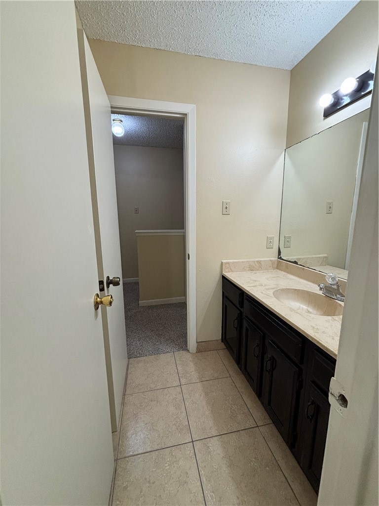 7214 Owen Court, Unit 2 Corpus Christi, TX 78413 - Photo 14 of 18 a bathroom with a double vanity sink and mirror