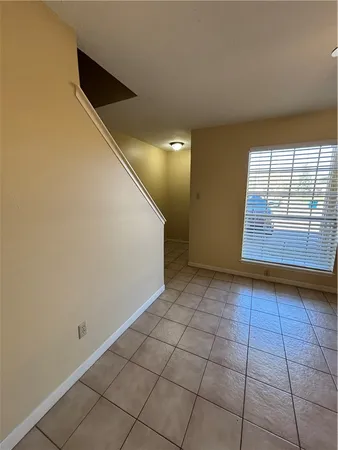a view of a livingroom with an empty space and a window