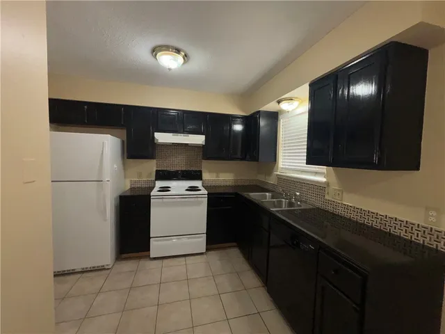 a kitchen with a sink and a refrigerator