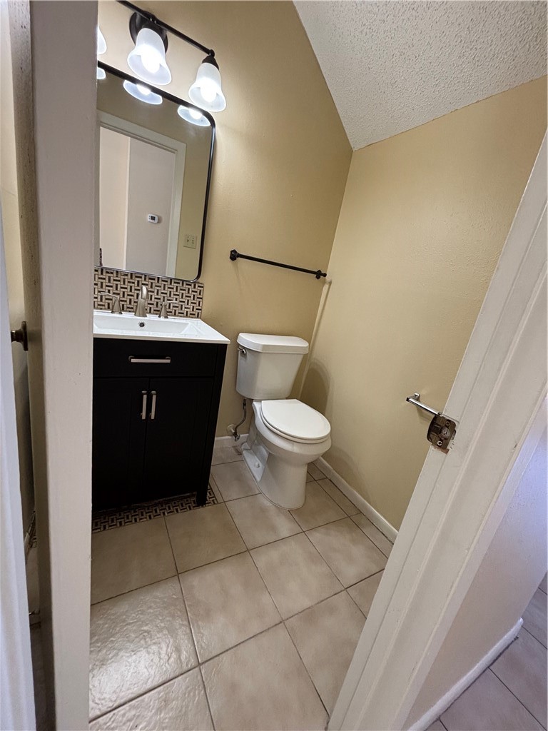 7214 Owen Court, Unit 2 Corpus Christi, TX 78413 - Photo 6 of 18 a bathroom with a toilet a sink and mirror