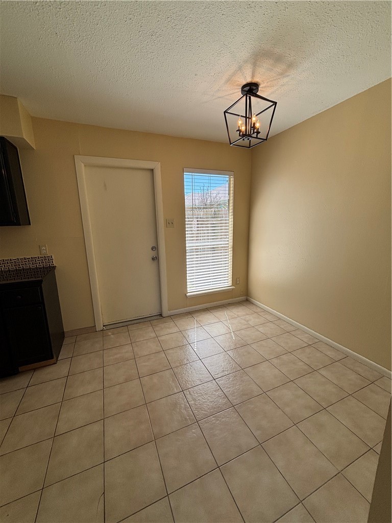 7214 Owen Court, Unit 2 Corpus Christi, TX 78413 - Photo 8 of 18 a view of empty room with window and chandelier