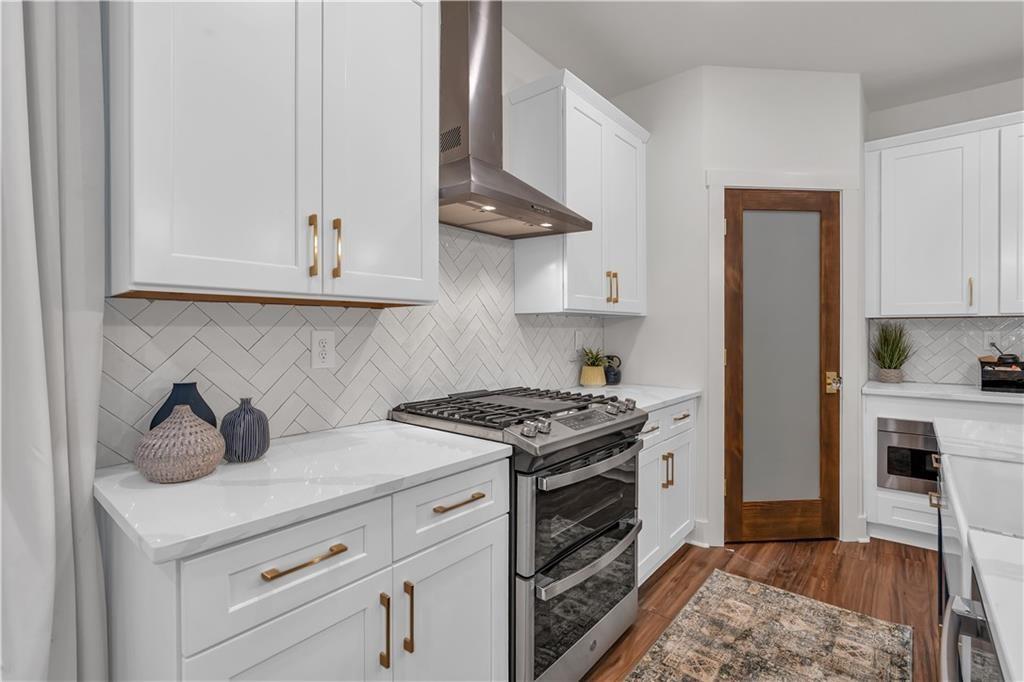 44 Puckett Road Emerson, GA 30137 - Photo 14 of 39 a kitchen with stainless steel appliances granite countertop a stove and a refrigerator