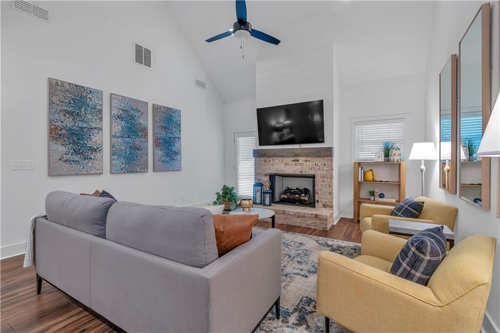 44 Puckett Road Emerson, GA 30137 - Photo 22 of 39 a living room with furniture a fireplace and a flat screen tv