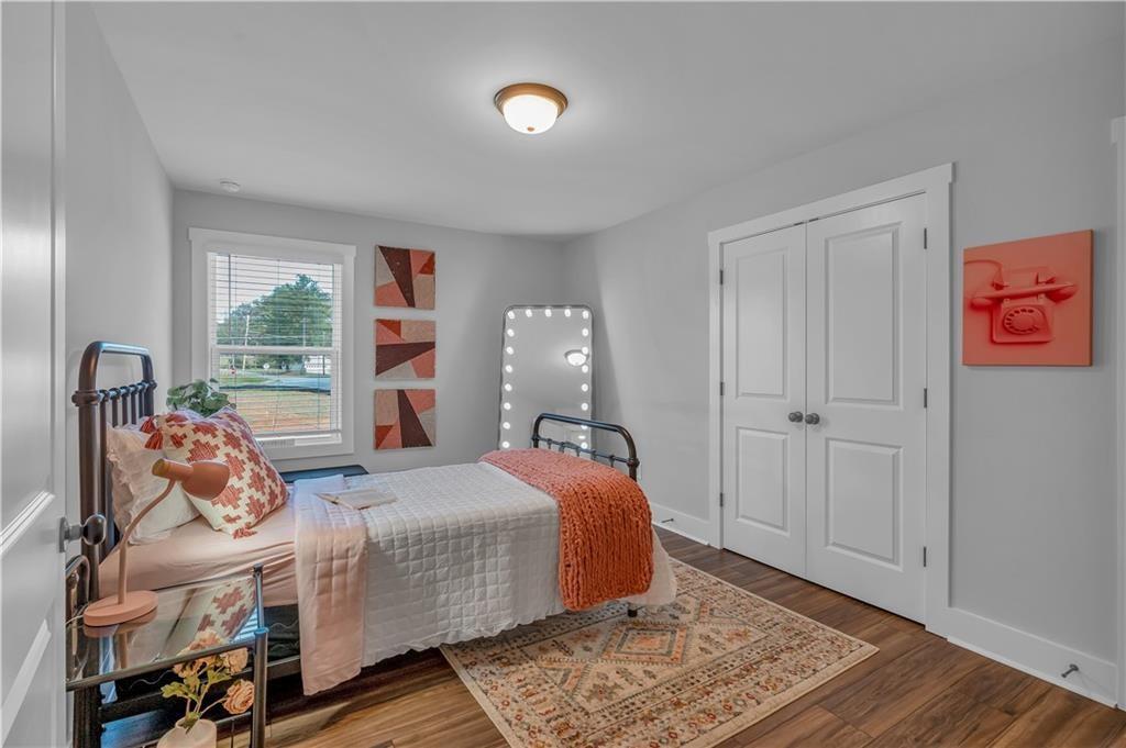 44 Puckett Road Emerson, GA 30137 - Photo 27 of 39 a bedroom with a bed and wooden floor