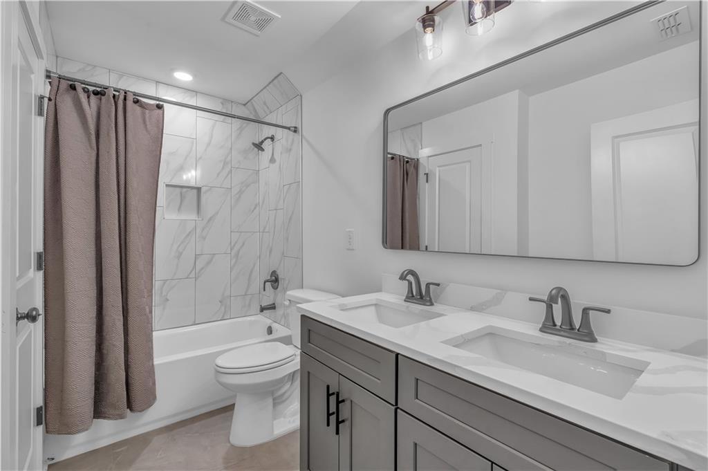 44 Puckett Road Emerson, GA 30137 - Photo 30 of 39 a bathroom with a granite countertop sink toilet a shower and a mirror