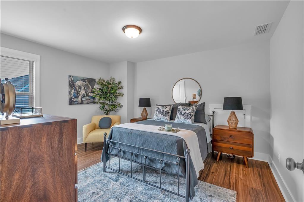 44 Puckett Road Emerson, GA 30137 - Photo 33 of 39 a bed room with a bed and a chandelier