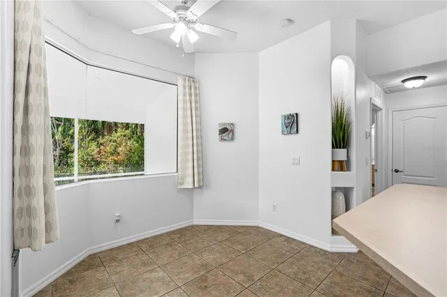 a view of an empty room with window and cabinet