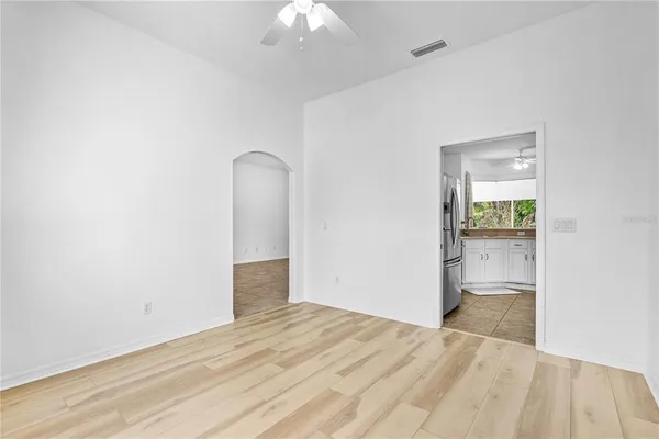 an empty room with a bathroom and mirror