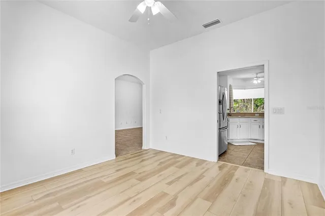 an empty room with a bathroom and mirror