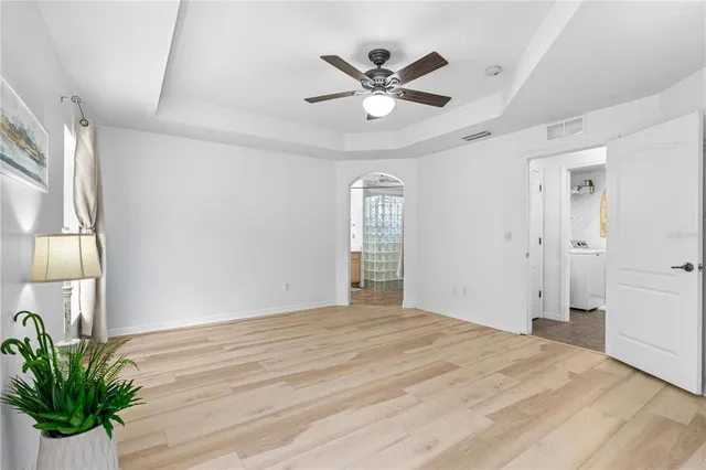 a view of a livingroom with a ceiling fan and window