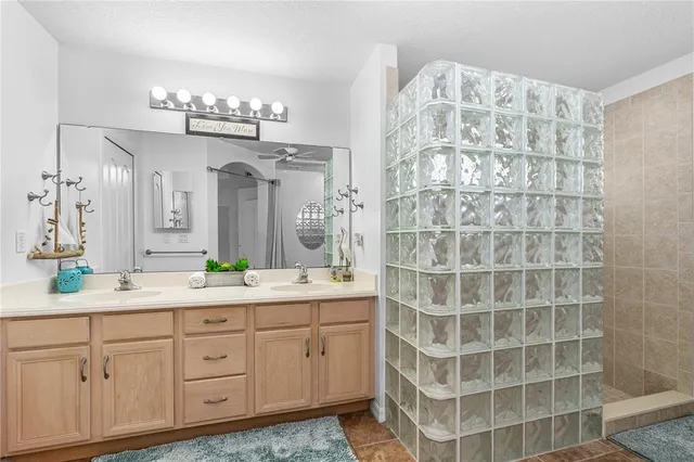a spacious bathroom with a double sink and a mirror