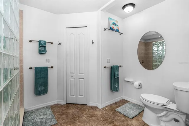a bathroom with a toilet and a shower
