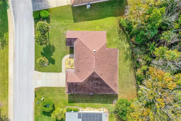 an aerial view of house with yard swimming pool and outdoor seating