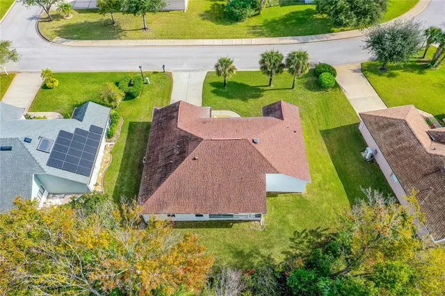 an aerial view of a house with a garden and plants