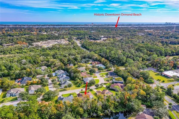 an aerial view of a houses with a yard