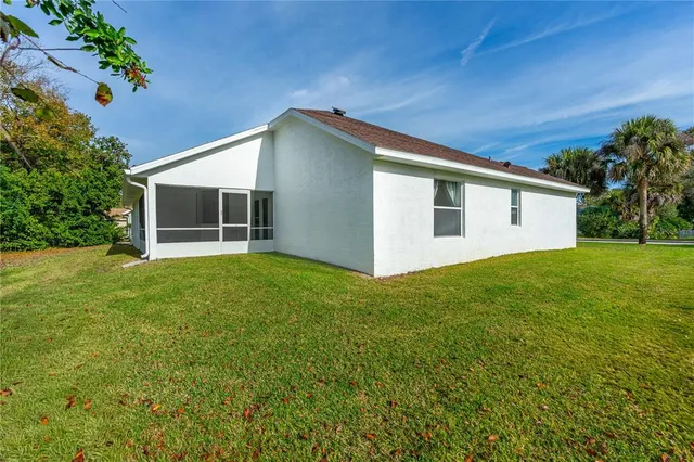 a view of a house with a backyard