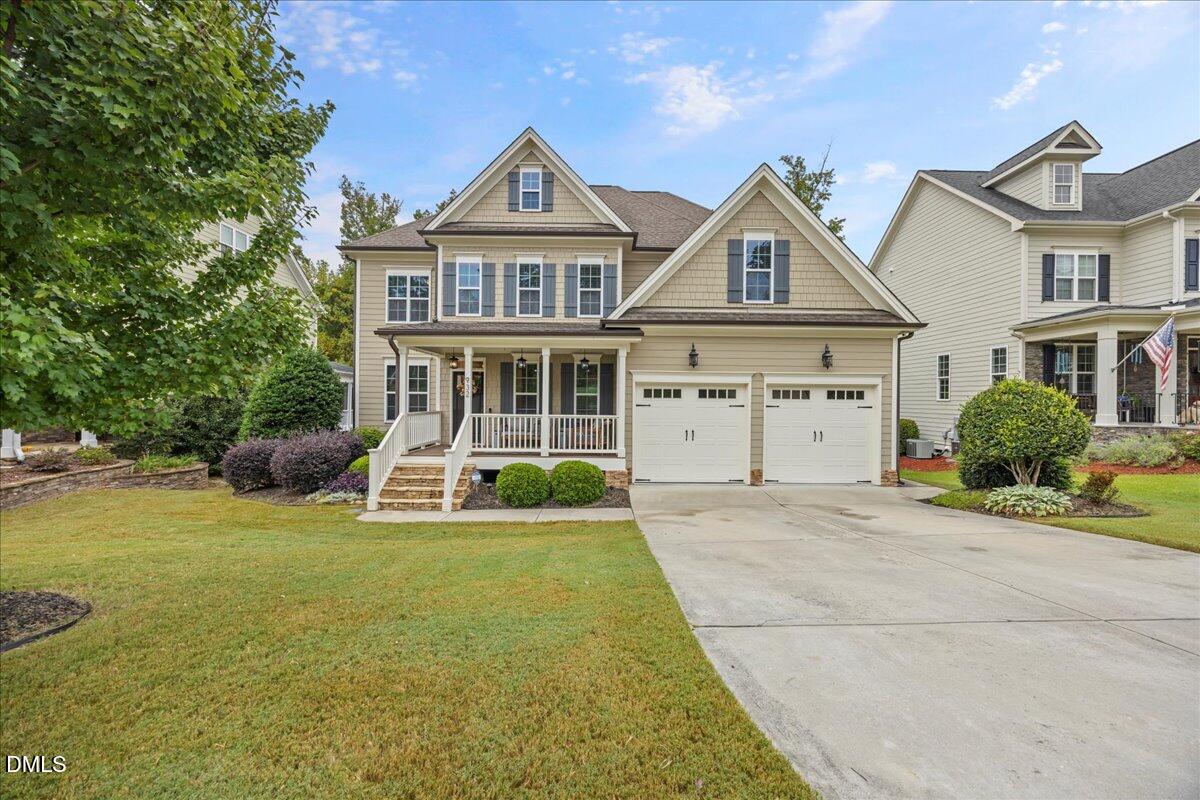 a front view of a house with a yard and garage
