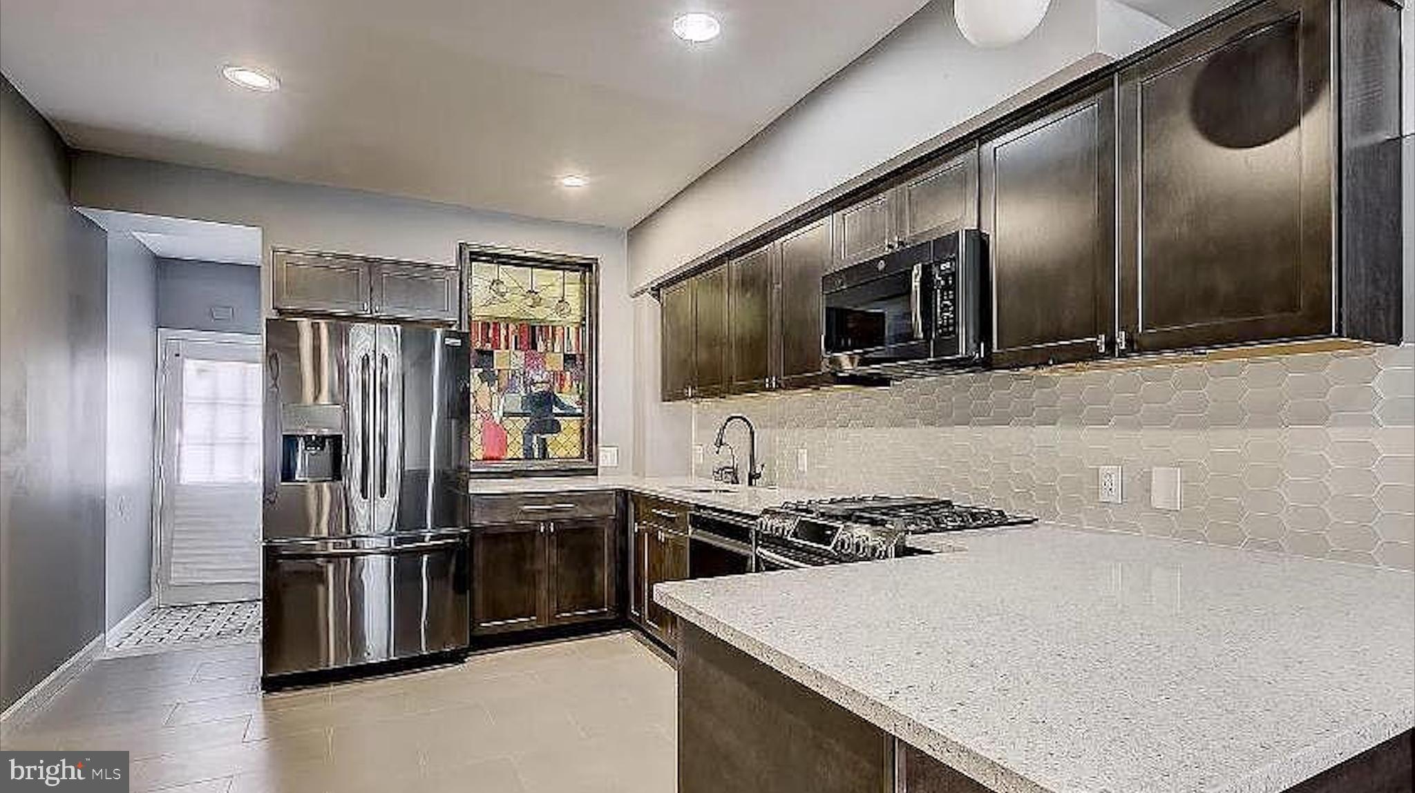 150 North Curley Street Baltimore, MD 21224 - Photo 3 of 10 a kitchen with stainless steel appliances granite countertop a refrigerator and a stove