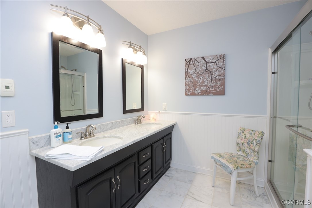 18300 River Road Chesterfield, VA 23838 - Photo 32 of 48 a bathroom with a double vanity sink and a mirror