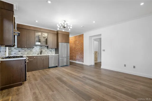 a view of a kitchen with a sink dishwasher cabinet and a mirror