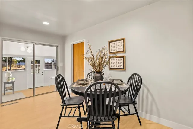 a view of a dining room with furniture and window