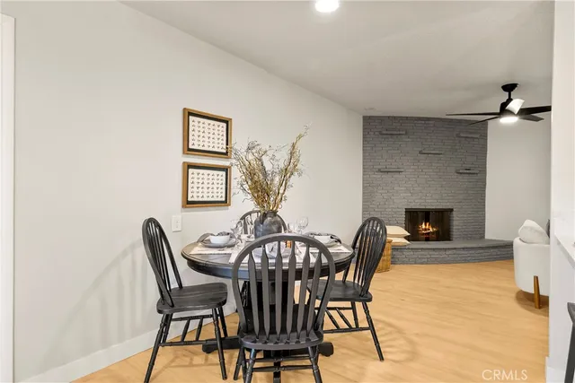 a view of a dining room with furniture and a fireplace