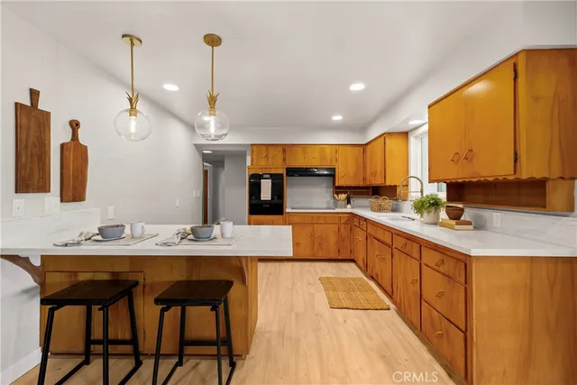 a large kitchen with stainless steel appliances kitchen island granite countertop a sink and cabinets