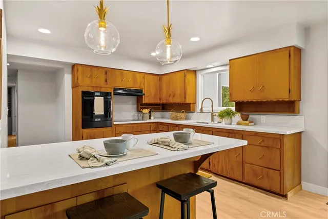 a kitchen with a sink cabinets and window