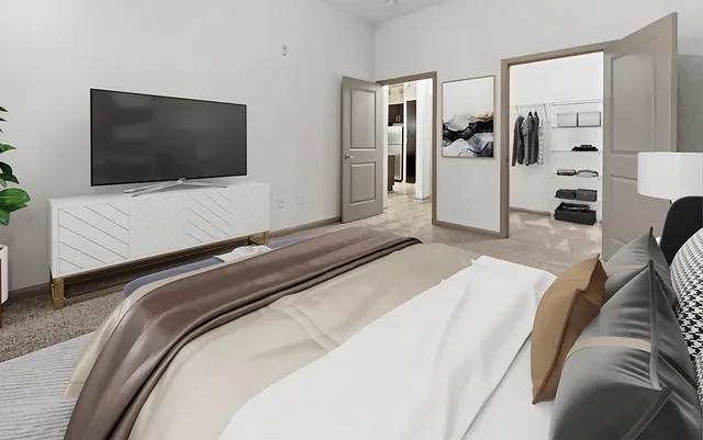 a bedroom with a bed and a flat screen tv