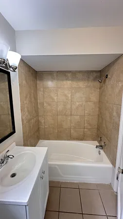 a bathroom with a bathtub and a sink