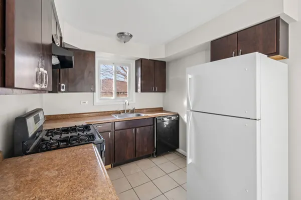 a kitchen with a refrigerator and a sink