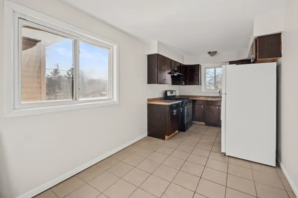 a kitchen with stainless steel appliances a refrigerator and a stove top oven