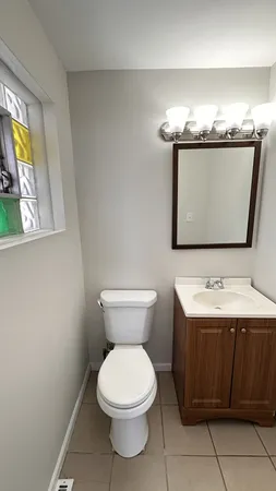a bathroom with a toilet sink and mirror
