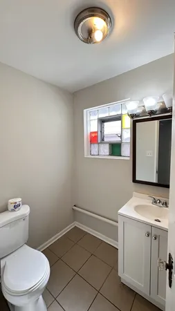 a bathroom with a toilet sink and mirror