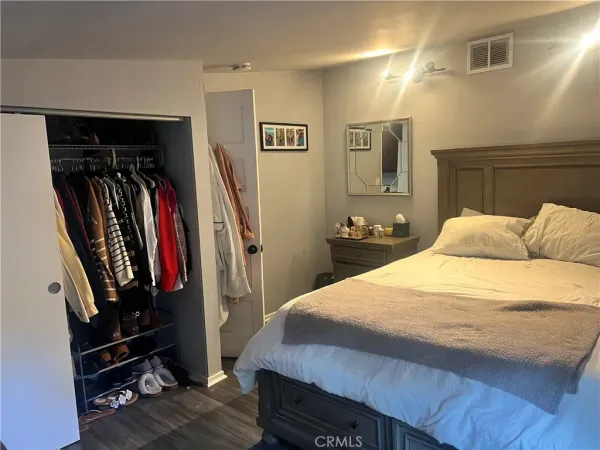 a bedroom with a bed a mirror and a desk