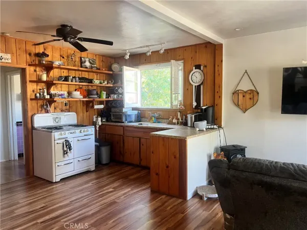 a kitchen with sink cabinets and wooden floor