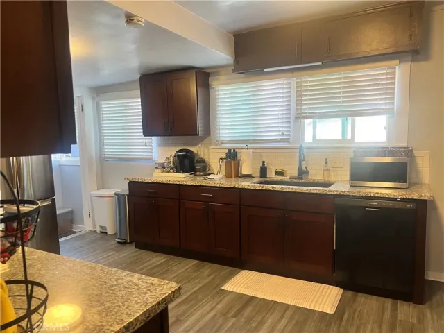 a kitchen with a sink and wooden cabinets