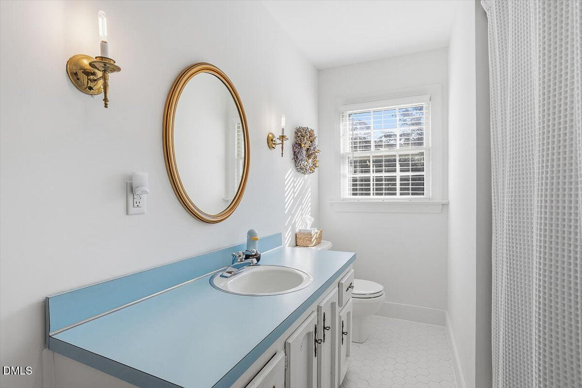 5904 Volant Drive Raleigh, NC 27609 - Photo 31 of 42 a bathroom with a sink and a mirror