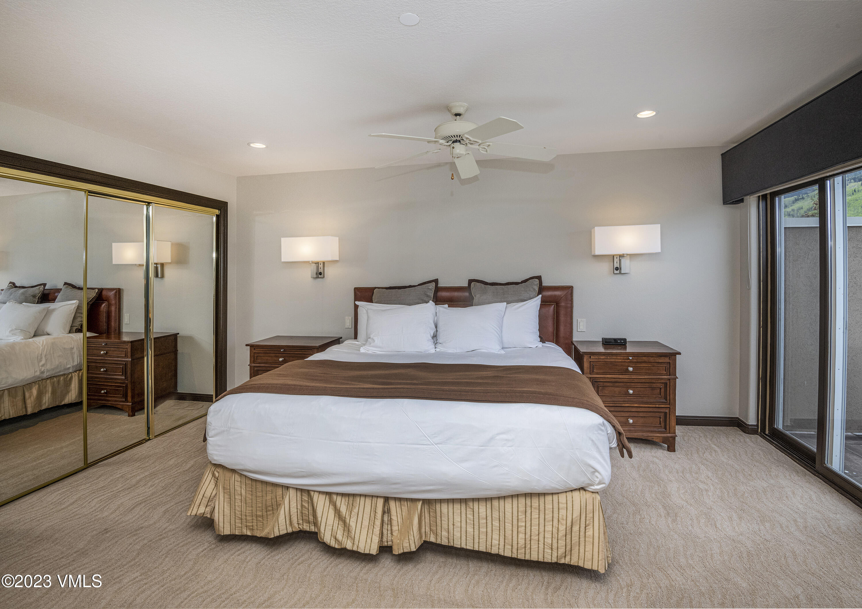210 Offerson Road, Unit 21026 Beaver Creek, CO 81620 - Photo 5 of 12 a spacious bedroom with a bed and a chandelier