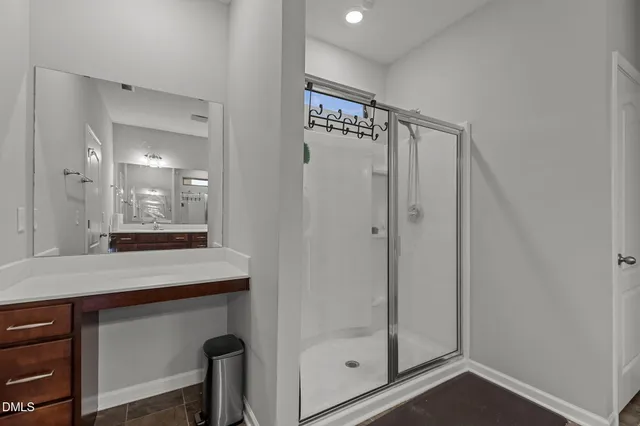 a bathroom with a shower sink and mirror