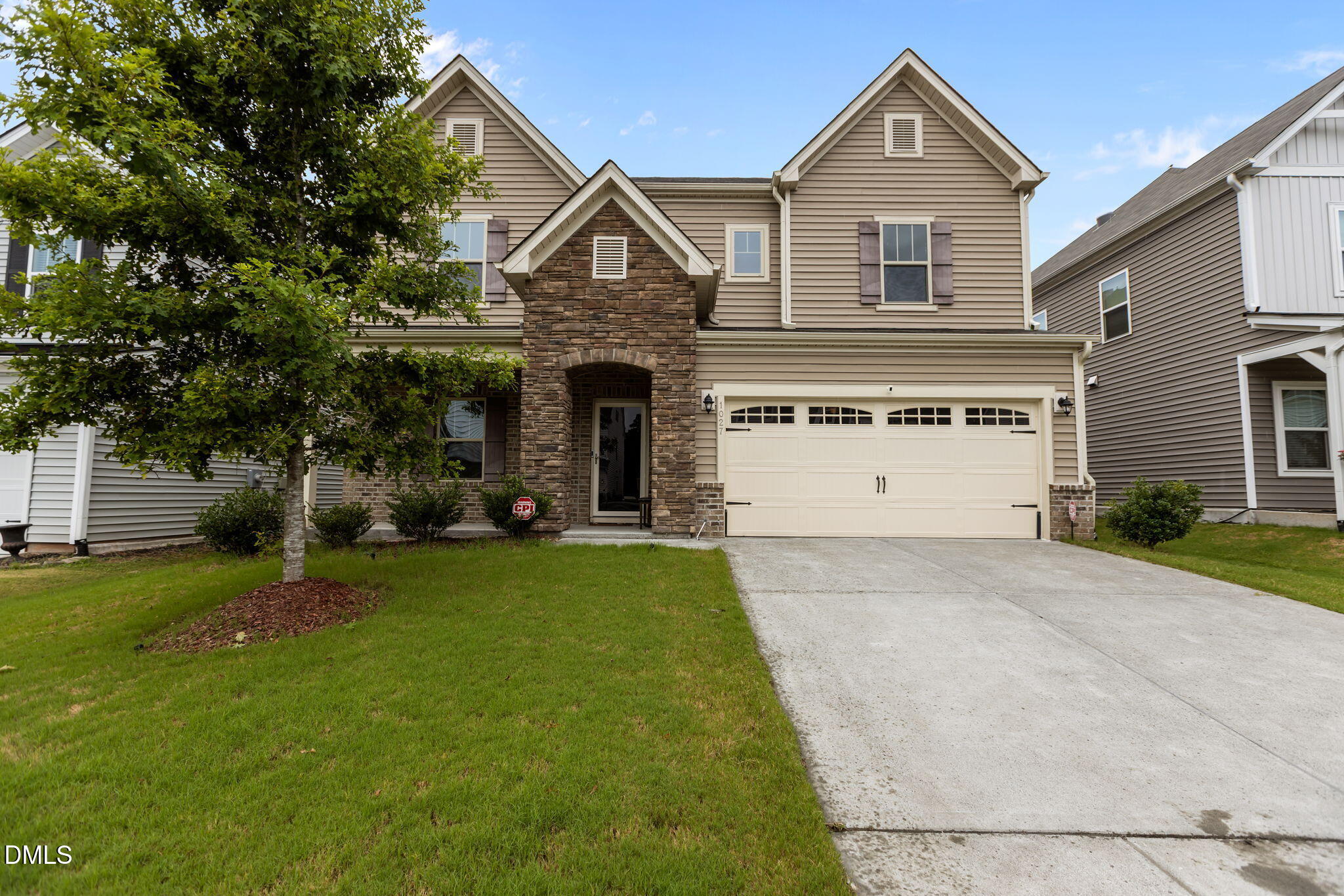 1027 Janiskee Road Durham, NC 27703 - Photo 4 of 36 a front view of a house with a yard and garage