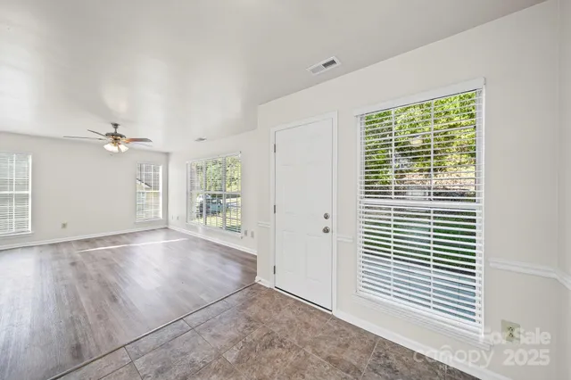 an empty room with windows and closet