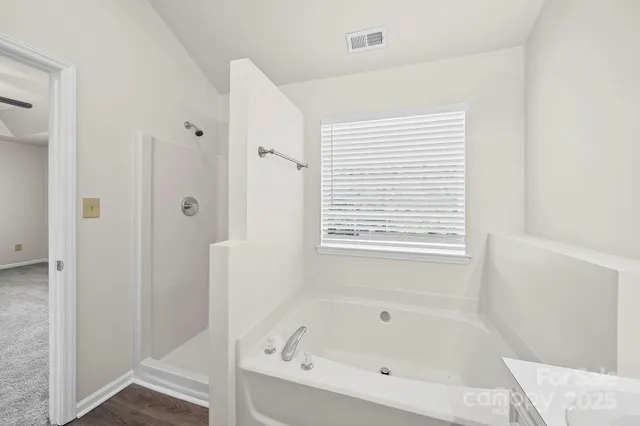 a white bath tub sitting next to a window