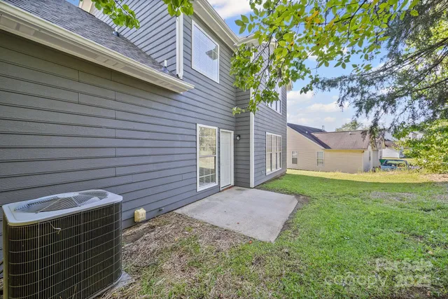 a view of a backyard with a large tree