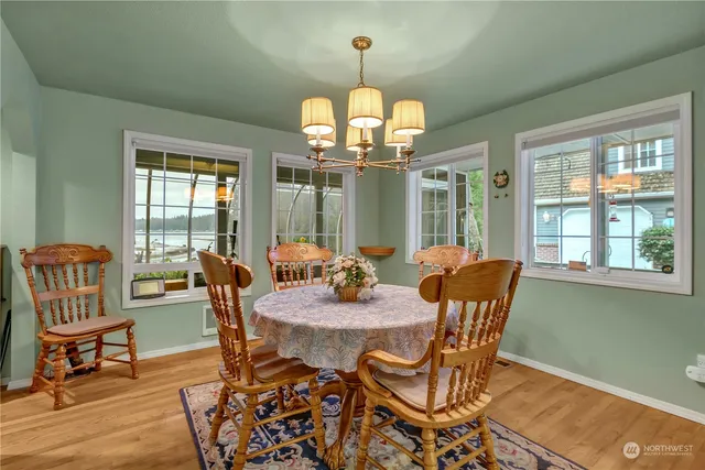 a view of a dining room with furniture wooden floor and chandelier