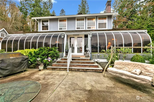 a view of a brick house with a yard in front of it
