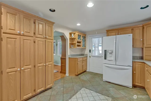 a kitchen with granite countertop cabinets and refrigerator