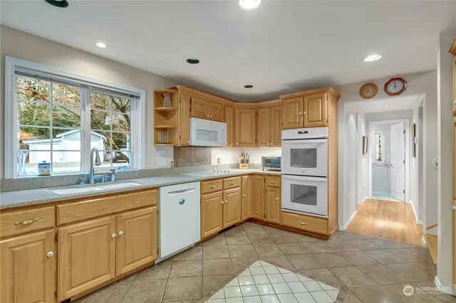 a kitchen with white cabinets and white appliances