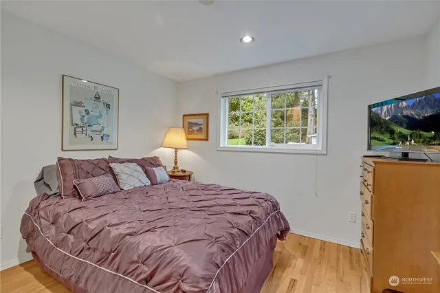 a bedroom with a bed and a flat screen tv