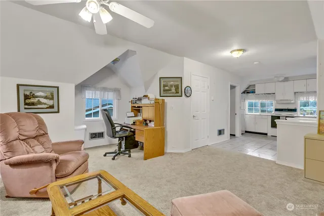 a living room with furniture and a chandelier